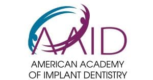 American Academy of Implant Dentistry logo recognizing Dr. Albert J. Kurpis as a Credentialed Fellow with decades of experience in dental implant surgery and implant reconstruction.